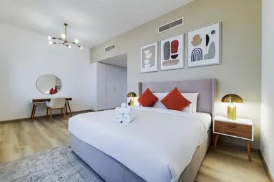 a bedroom with a large white bed and a desk at Sadaf 6, JBR - Remarkable Two Bedroom in Dubai
