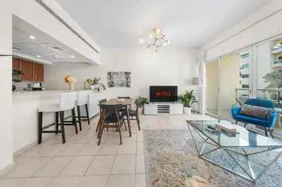 a living room with a kitchen and a dining room at Gorgeous One Bedroom Apartment in the heart of Dubai in Dubai