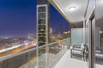 a balcony with a view of a city at night at ALiving Luxury 2BR with Infinity Pool I Near Dubai Mall & Burj Khalifa I Paramount Hotel Midtown in Dubai