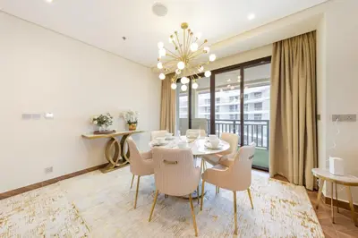 a dining room with a table and chairs at EDEN'S Homes & Villas - Anantara The Palm Residences in Dubai