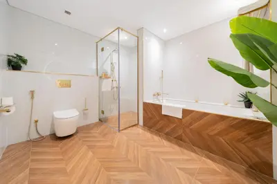 a bathroom with a glass shower and a toilet at EDEN'S Homes & Villas - Anantara The Palm Residences in Dubai