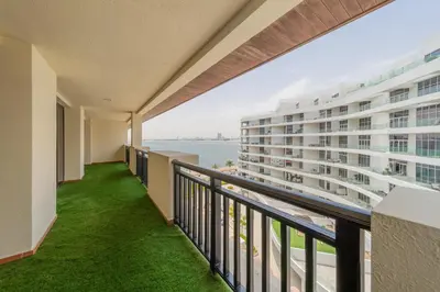 a balcony with a view of the ocean at EDEN'S Homes & Villas - Anantara The Palm Residences in Dubai