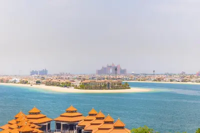 a view of a beach with orange domed buildings at EDEN'S Homes & Villas - Anantara The Palm Residences in Dubai