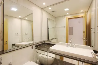 a bathroom with two sinks and a toilet at Livbnb Suites - 1BR with Sea View & Beach Access in Dubai