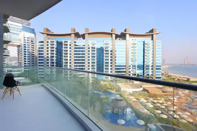 a balcony with a view of a large building at Livbnb Suites - 1BR with Sea View & Beach Access in Dubai