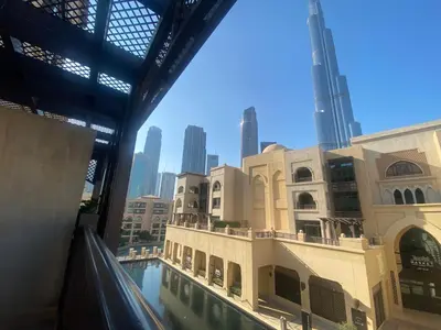 a view of a building with a swimming pool at Durrani Homes - Souk Al Bahar Living Besides Burj khalifa & Fountain in Dubai