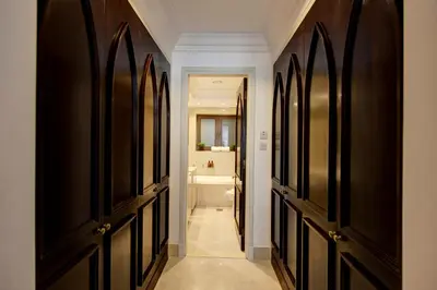a hallway with black and white doors and a bathroom at Durrani Homes - Souk Al Bahar Living Besides Burj khalifa & Fountain in Dubai