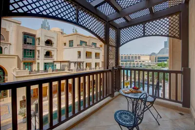 a balcony with a table and chairs in a building at Durrani Homes - Souk Al Bahar Living Besides Burj khalifa & Fountain in Dubai