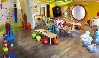 a childrens play area with tables and chairs in a room at Fairmont The Palm Residences I Access to Hotel Facilities in Dubai