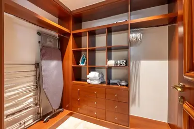 a walk in closet with wood paneling and a glass door at Fairmont The Palm Residences I Access to Hotel Facilities in Dubai