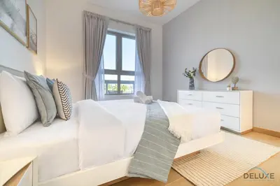 a living room with a white couch and a window at Placid 1BR at La Cote 5 Jumeirah 1 by Deluxe Holiday Homes in Dubai