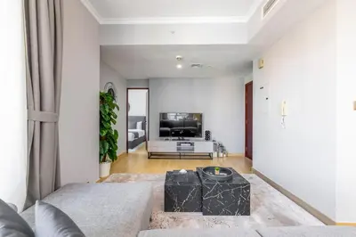 a living room with a couch and a tv at Downtown Luxury I 5 Min Walk To Dubai Fountain! in Dubai