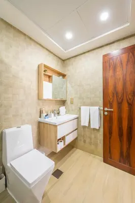 a bathroom with a toilet and a sink at Downtown Luxury I 5 Min Walk To Dubai Fountain! in Dubai