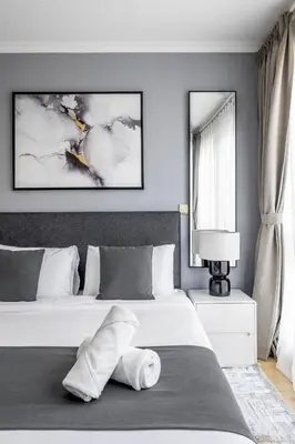 a bedroom with two beds and a large window at Downtown Luxury I 5 Min Walk To Dubai Fountain! in Dubai