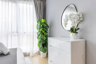 a bedroom with a mirror and a white dresser at Downtown Luxury I 5 Min Walk To Dubai Fountain! in Dubai