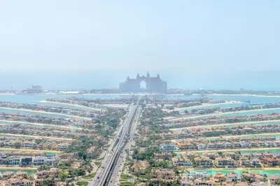 an aerial view of a city with a building in the distance at Ultra Luxury Palm Tower with Shared Hotel Facilities in Dubai