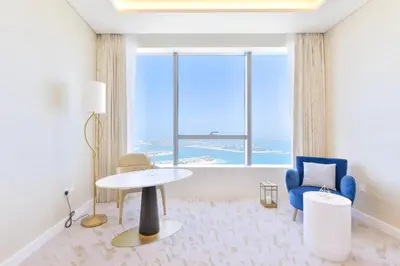 a room with a table and chairs and a large window at Ultra Luxury Palm Tower with Shared Hotel Facilities in Dubai