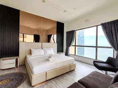 a bedroom with a large bed and a large window at ELAN RIMAL SADAF Suites in Dubai