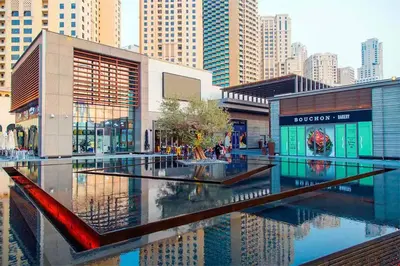 a building with a pool of water in a city at ELAN RIMAL SADAF Suites in Dubai