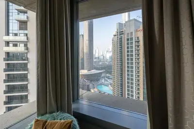 a window with a view of a city at Bellavista - Glamorous - 2BR - 29 Boulevard - Burj Khalifa & Fountain View in Dubai