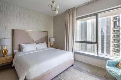 a bedroom with a large bed and a large window at Bellavista - Glamorous - 2BR - 29 Boulevard - Burj Khalifa & Fountain View in Dubai