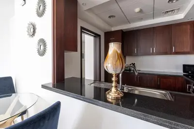 a kitchen with a sink and a lamp on a counter at Bellavista - High Floor - 1BR - 29 Boulevard - Full Burj Khalifa & Fountain View in Dubai