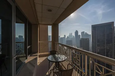 a balcony with a table and a view of the city at Bellavista - High Floor - 1BR - 29 Boulevard - Full Burj Khalifa & Fountain View in Dubai