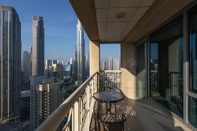 a balcony with a table and chairs on a building at Bellavista - High Floor - 1BR - 29 Boulevard - Full Burj Khalifa & Fountain View in Dubai