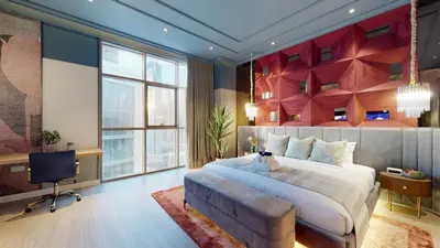 a bedroom with a bed and a desk and a television at High-End Designer Penthouse Full Burj Khalifa View in Dubai