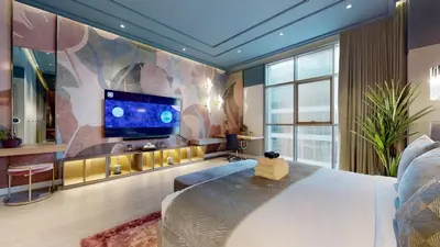 a bedroom with a large bed and a flat screen tv at High-End Designer Penthouse Full Burj Khalifa View in Dubai