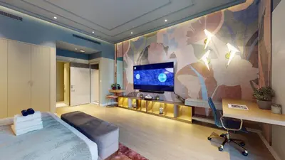 a bedroom with a tv and a bed and a desk at High-End Designer Penthouse Full Burj Khalifa View in Dubai