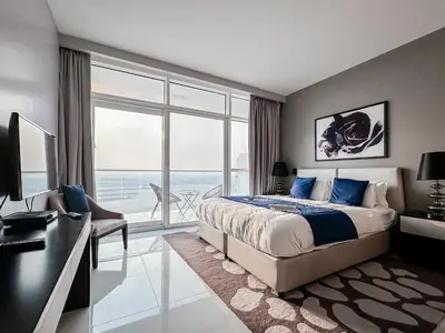 a bedroom with a bed and a desk and a window at Trophy Stays - Peaceful Golf side Escape Studio - Damac Hills in Dubai