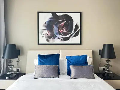 a bedroom with a bed with a picture on the wall at Trophy Stays - Peaceful Golf side Escape Studio - Damac Hills in Dubai