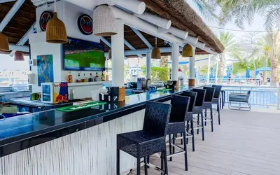 a bar with a row of chairs at a resort at Luxury Beachfront Palm Jumeirah I Free 5 Star Beach Resorts Access in Dubai