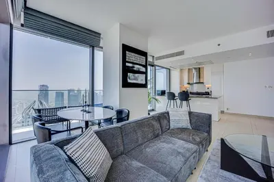a living room with a couch and a table at Spacious 2 Bedroom in Marina Gate Jumeirah Living in Dubai