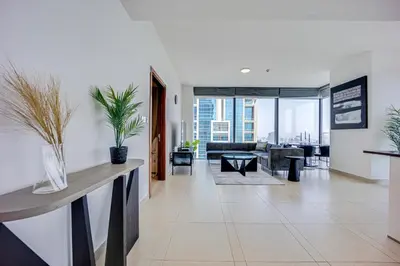 a living room with a couch and a table at Spacious 2 Bedroom in Marina Gate Jumeirah Living in Dubai