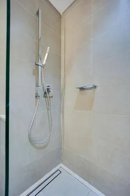 a shower with a shower head in a bathroom at Spacious 2 Bedroom in Marina Gate Jumeirah Living in Dubai