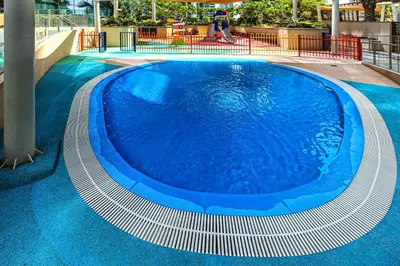 a large blue swimming pool in a building at Spacious 2 Bedroom in Marina Gate Jumeirah Living in Dubai