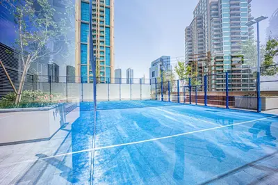 a tennis court in the middle of a city at Spacious 2 Bedroom in Marina Gate Jumeirah Living in Dubai