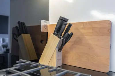 a group of knives in wooden cutting boards at Cosmopolitan Apartment with Burj Khalifa View in Dubai