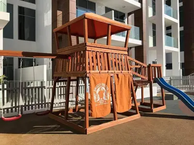 a playground with a slide and a swing at Cozy studio in heart of Dubai - JVC in Dubai