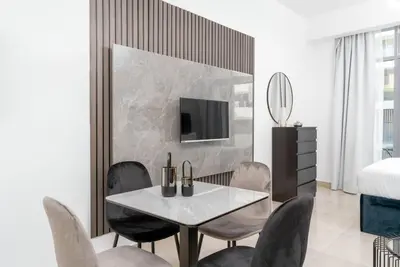 a dining room with a table and chairs at Cozy studio in heart of Dubai - JVC in Dubai