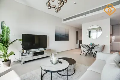 a living room with a couch and a tv and a table at Keysplease Luxury 1 BR Apt Address W Private Beach, JBR in Dubai
