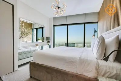 a bedroom with a large bed and large windows at Keysplease Luxury 1 BR Apt Address W Private Beach, JBR in Dubai