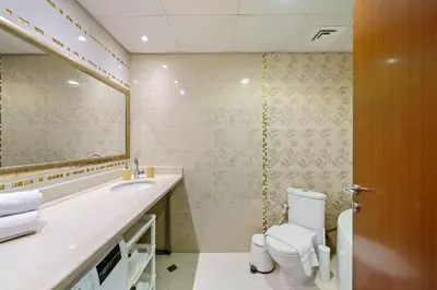 a bathroom with a toilet and a sink and a mirror at 2BR in JBR / Sea View / Dubai Marina / Walk2Beach in Dubai