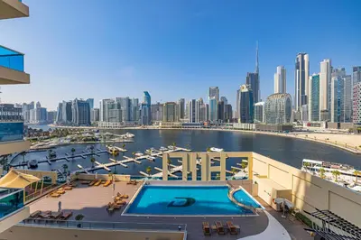 a view of a city skyline with a swimming pool at Daniels 1BR Business Bay Partial Burj Khalifa View in Dubai
