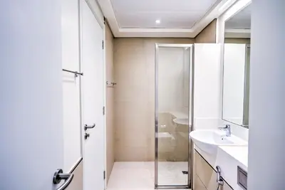 a bathroom with a shower and a sink at Expo Village Serviced Apartments in Dubai
