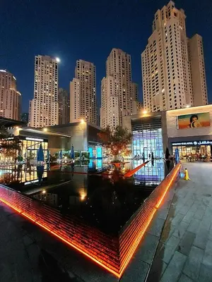 a city skyline with tall buildings at night at Al Bateen · Ultra Luxury JBR · Private Beach and Pool in Dubai