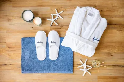 a pair of flip flops and a towel next to a pair of towelsurrection at Al Bateen · Ultra Luxury JBR · Private Beach and Pool in Dubai