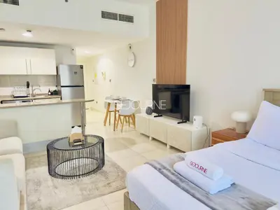 a living room with a bed and a kitchen at DA86 - Well Design Studio in Dubai Arch tower in Dubai